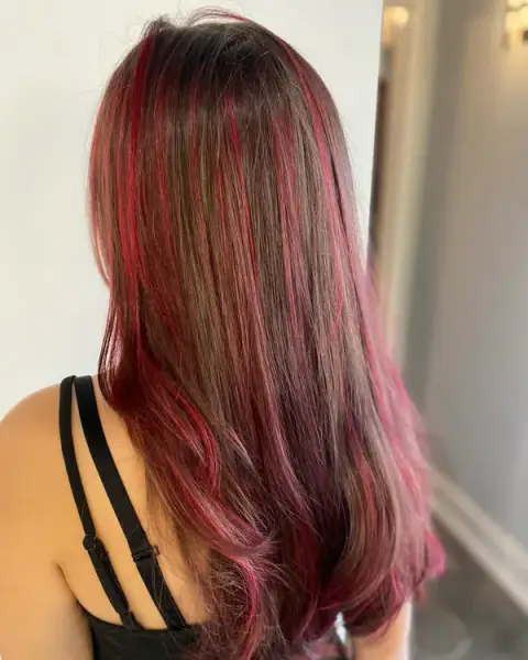 Vibrant red hair color by Backstage Salon stylists